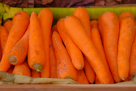 Carrots on dry banana leaf in basketの写真素材