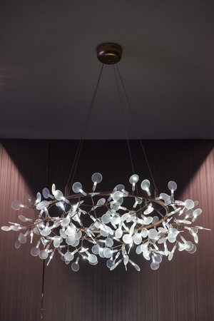 Close up of a beautiful chandelier on ceilingの写真素材