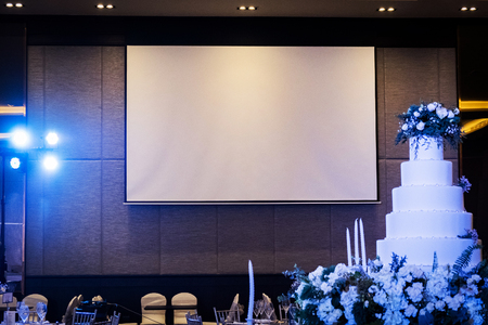 Front view of wedding room with empty white projector screen