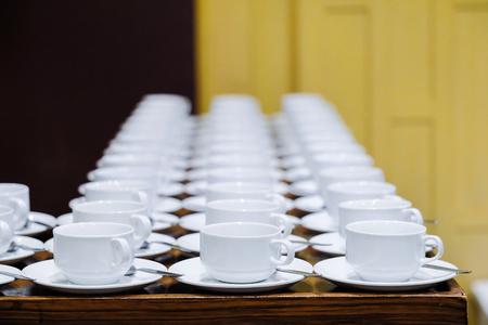 Many rows of white ceramic coffee or tea cups.の写真素材