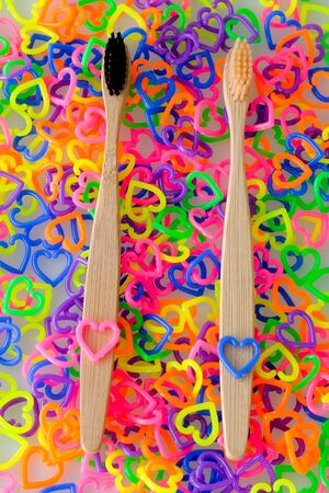 Two toothbrushes on colorful mini  heart toy plasticの写真素材