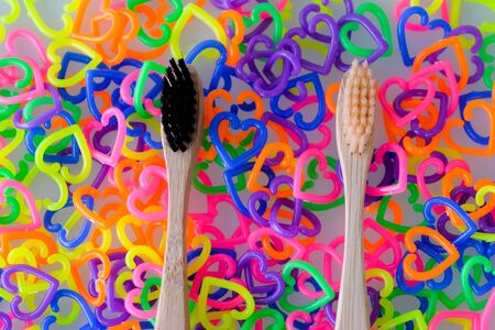 Two toothbrushes on colorful mini  heart toy plasticの写真素材