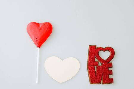 Heart shaped chocolate candy ,paper and word LOVE on white backgroundの写真素材