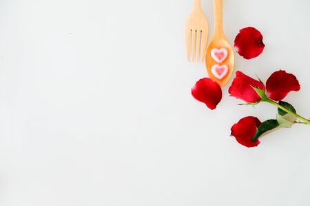 Two jelly shape heart on wood spoon and rose isolated on white backgroundの写真素材