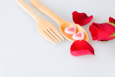 Two jelly shape heart on wood spoon and rose isolated on white backgroundの写真素材