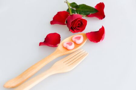 Two jelly shape heart on wood spoon and rose isolated on white backgroundの写真素材