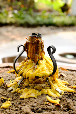 Candle dripping from  old candlestick with natural background.の写真素材