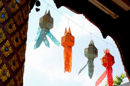 Colorful Lanna hanging lamp in temple at Thailand,isolated blue sky.の写真素材
