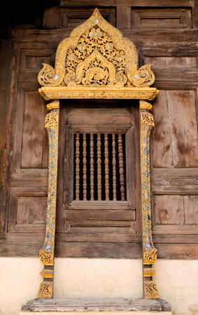 Old window in temple of  Wat Phan TaoTemple, Chiang Mai, Thailand.の写真素材