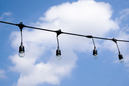 Clear string lights on blue sky backgroundの写真素材