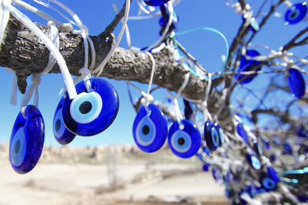 Evil eye charms hang from a tree in Cappadocia, Turkey の写真素材