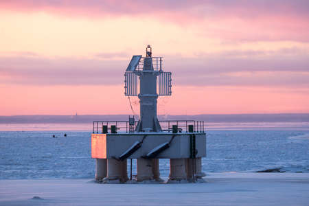 View of a navigational white sign with solar panels at sunset against a beautiful skyの写真素材