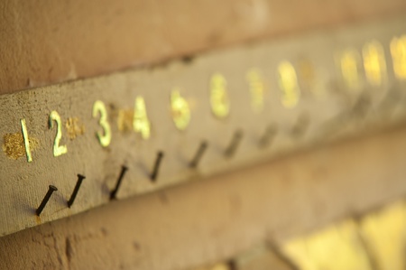 Old board with rusty nails and numbersの写真素材