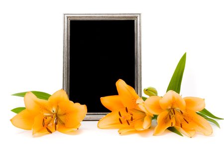 Yellow lilies and silver frame on a white backgroundの写真素材