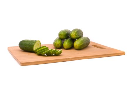 Fresh cucumbers on a chopping boardの写真素材