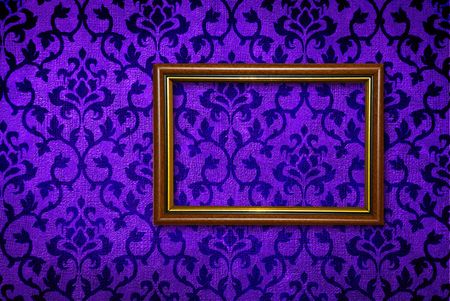 Gold frame on a vintage blue wall backgroundの写真素材