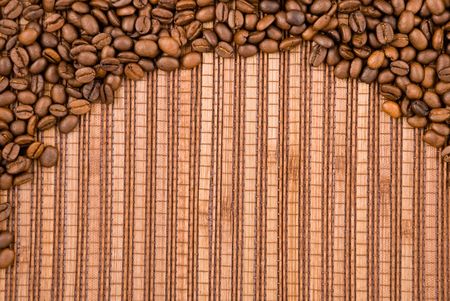 Coffee beans on the wooden backgroundの写真素材