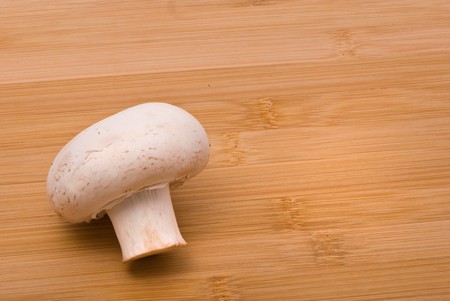 Fresh mushrooms on a chopping boardの写真素材