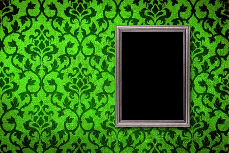 Silver frame on a vintage green wall backgroundの写真素材