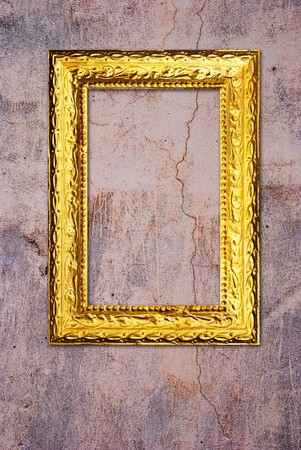 Gold frame on a old wall backgroundの写真素材