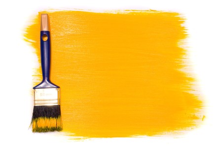 Brush with yellow paint on the white backgroundの写真素材