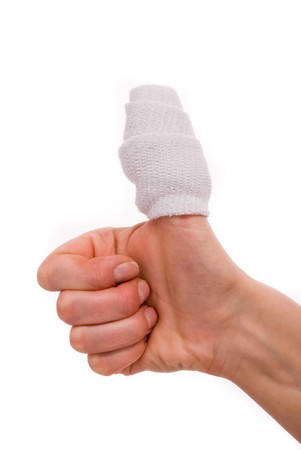 White medicine bandage on human injury hand finger. Studio isolated.の写真素材