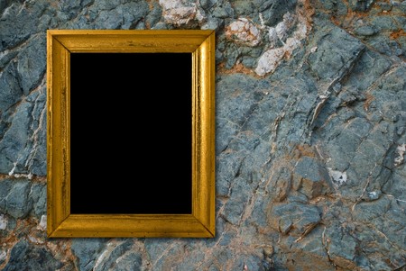 Stone background with vintage gold frameの写真素材