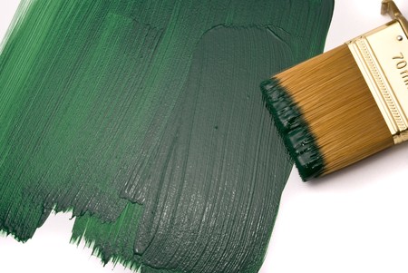 Brush with green paint on the white backgroundの写真素材