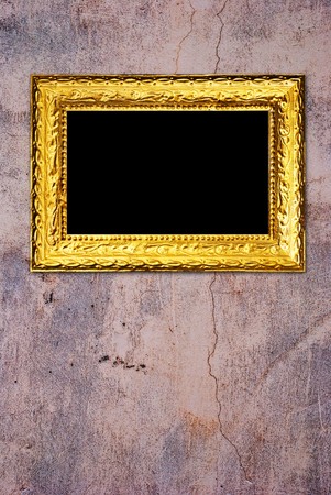 Gold frame on a old wall backgroundの写真素材