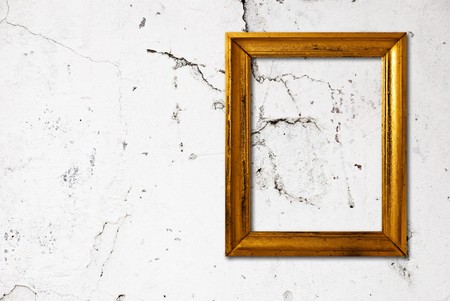Gold frame on a old wall backgroundの写真素材