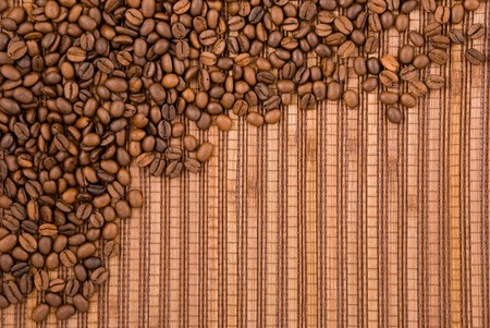 Coffee beans on the wooden backgroundの写真素材