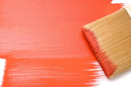 Brush with red paint on the white backgroundの写真素材