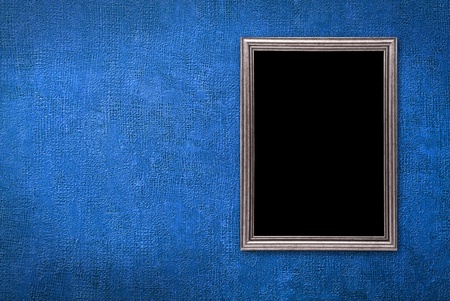 Silver frame on a old blue wall background