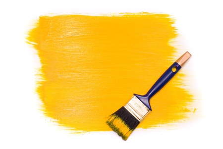 Brush with yellow paint on the white backgroundの写真素材