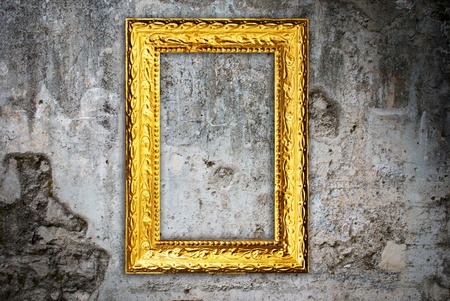 Gold frame on a old wall backgroundの写真素材