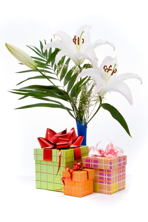 Beautiful bouquet in the basket and present boxes on a white backgroundの写真素材