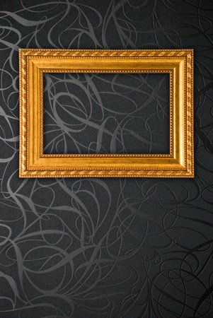 Gold frame on black vintage wallpaper backgroundの写真素材