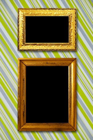 Gold frame on striped vintage wallpaper backgroundの写真素材