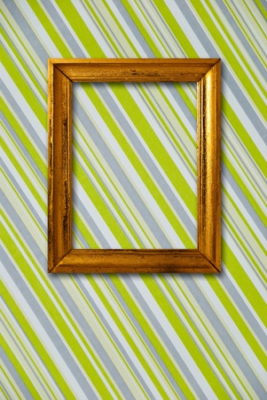 Gold frame on striped vintage wallpaper backgroundの写真素材