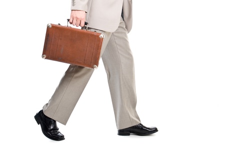Walking man holding an old suitcase isolated over white backgroundの写真素材