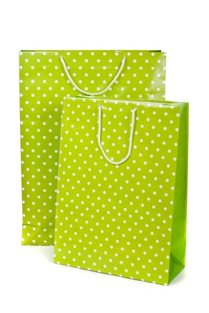 Green paper shopping bag isolated on white backgroundの写真素材