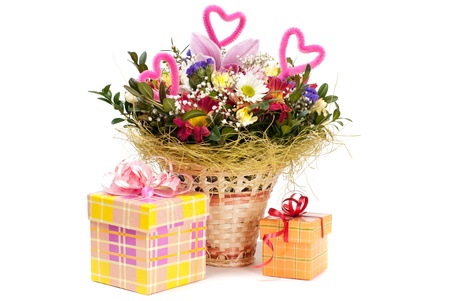 Beautiful bouquet in the basket and present boxes on a white backgroundの写真素材