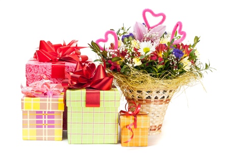 Beautiful bouquet in the basket and present boxes on a white backgroundの写真素材