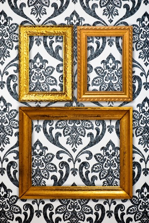 Gold frame on vintage wallpaper backgroundの写真素材