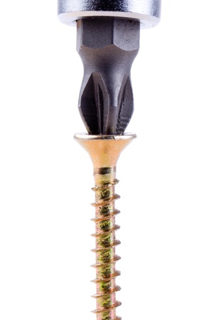 Closeup image of screwdriver and single screw in board on white background.の写真素材