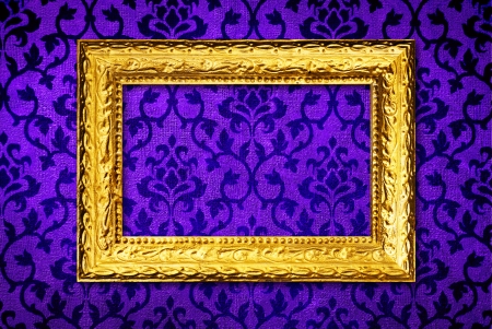 Gold frame on a vintage blue wall backgroundの写真素材