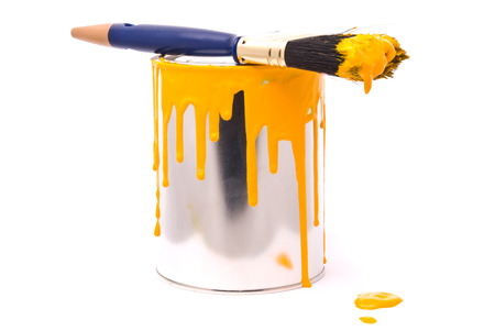 Can of yellow paint and professional brush on a whiteの写真素材