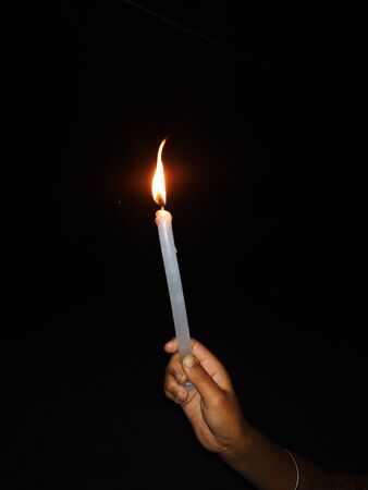 Janta Curfew - A girl holding a candle as urged by Indian PM Modi .This Photo is taken by vishal singh in Biharの写真素材