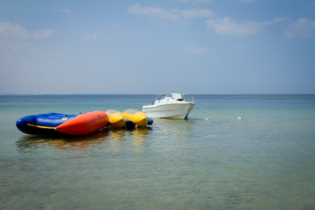Modern inflatable boat with engine in the sea near shoreの写真素材