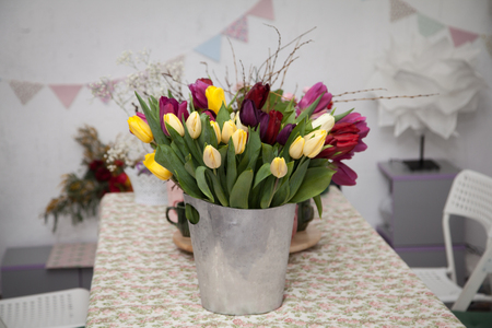 A bouquet of tulip flowers in a metal bucketの写真素材